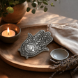 Polished Aluminium Hamsa Incense Holder 14cm — styled in a warm, naturally lit interior