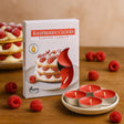 Raspberry cloud scented candles with packaging and raspberries on a wooden surface