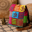 Colorful bag with Om symbols on a patterned rug