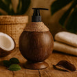 Coconut-shaped bottle with pump on a wooden surface with coconuts and leaves in the background