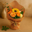 Bouquet of flowers wrapped in brown paper with a beige background
