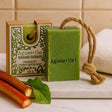Green soap bar with rope and packaging labeled 'Agnes + Cat' on a bathroom counter.