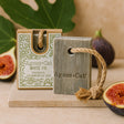Agnes + Cat white fig soap with packaging on a wooden surface with figs in the background