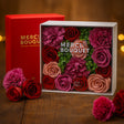 Box of preserved flowers with 'Mercl Bouquet' branding on a wooden surface.