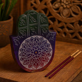Decorative wooden Hamsa with floral patterns on a wooden surface