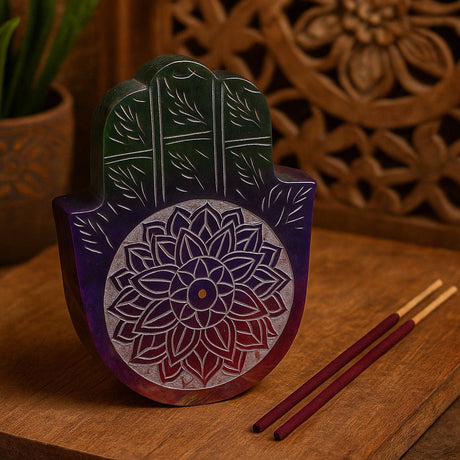 Decorative wooden Hamsa with floral patterns on a wooden surface