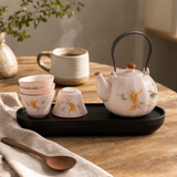 Travel Teapot Set & Four Cups - Pink Vintage Pumpkin Style — styled in a warm, naturally lit interior