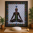 Yoga mat with chakra symbols on a wall above a meditation cushion and candle.