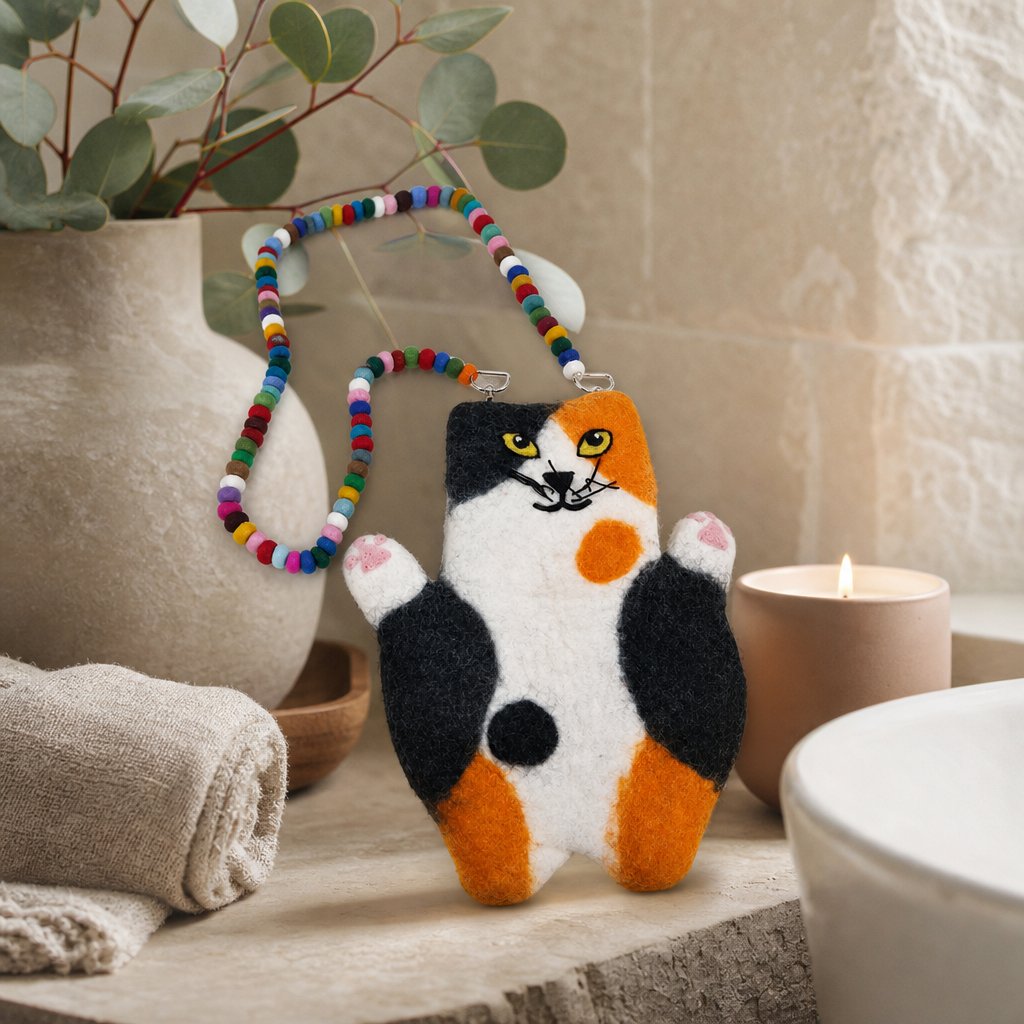 Whitney the Flat Cat Felted Bag — styled in a warm, naturally lit interior